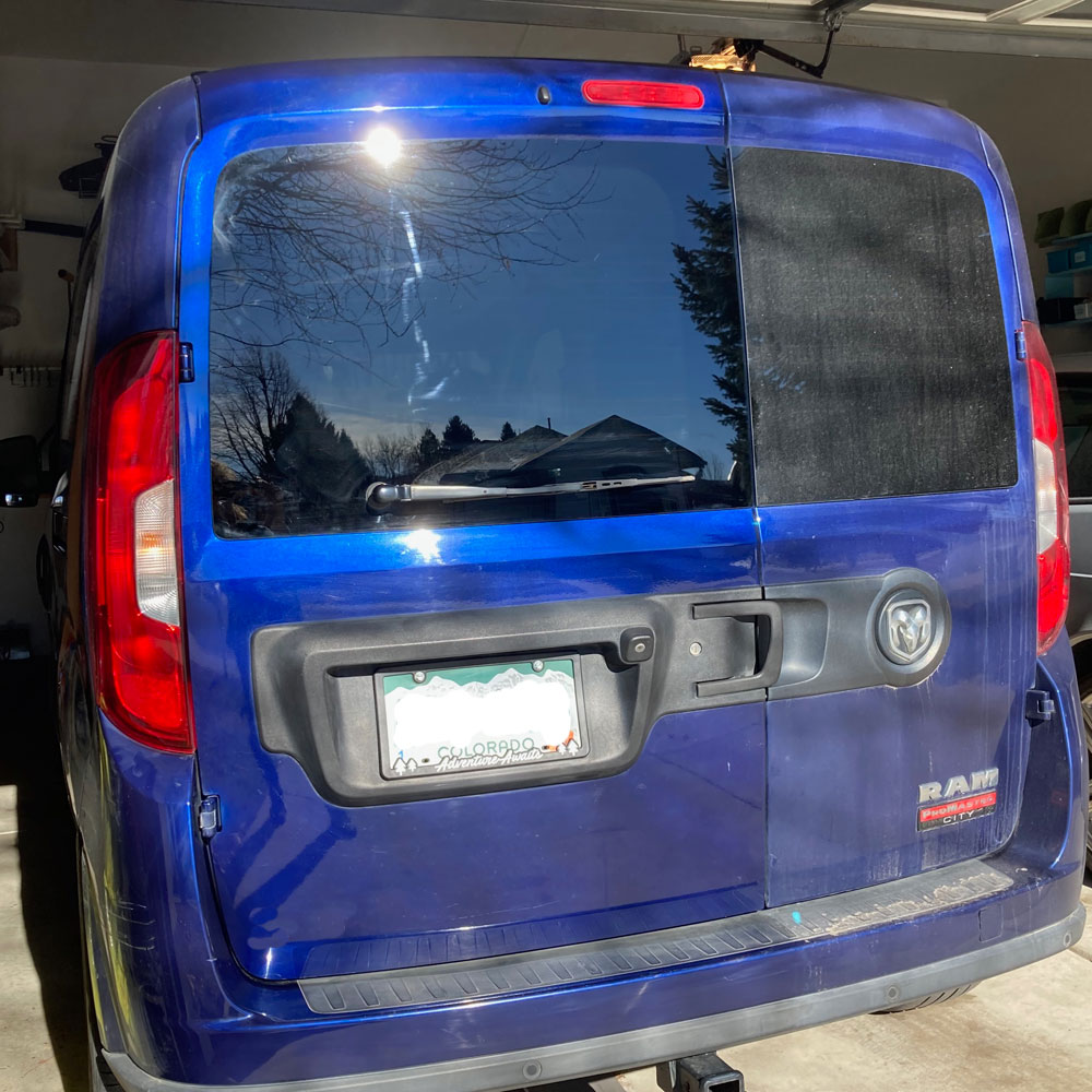 a blue van in a garage left door has had vehicle cleaning with fw1 wax