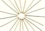 a group of gold filled pins in a circle