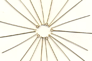 a group of gold filled pins in a circle