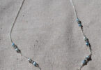 a sterling silver necklace with pearls on it