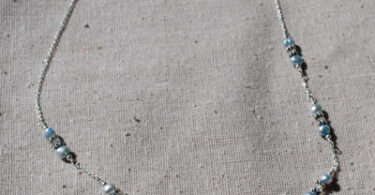 a sterling silver necklace with pearls on it