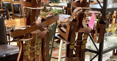 metal sculptures of figures playing instruments