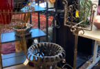 collection of metal furniture and decor in a thrift shop