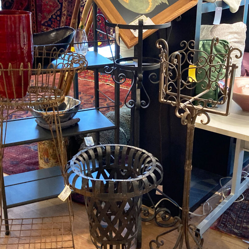 collection of metal furniture and decor in a thrift shop