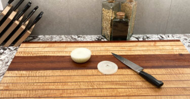 wooden cutting boards knifes and onion
