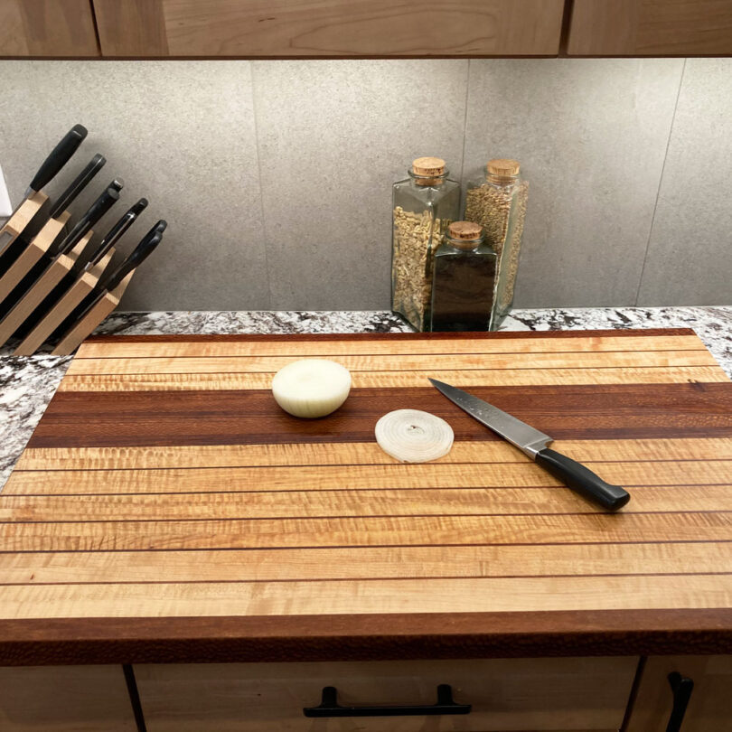 wooden cutting boards knifes and onion