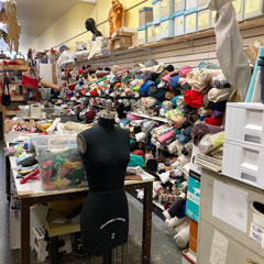 craft thrift store wall of fabric mannequins yarn
