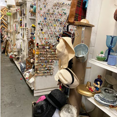 wall of thread spools vintage hats picture frames