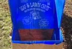 blue leaf bag chute with a brown leaf bag on grass