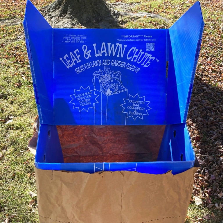 blue leaf bag chute with a brown leaf bag on grass