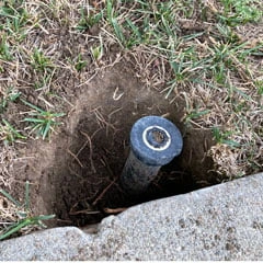 dig out soil around popup sprinkler convert to drip irrigation