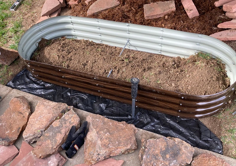 placing the raised bed planter irrigation detail
