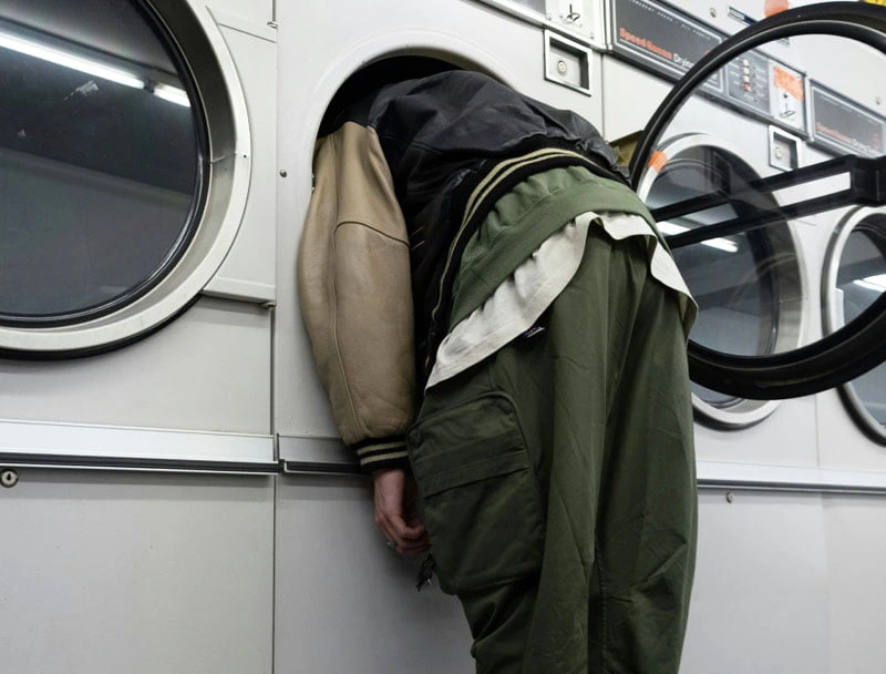 person examining stinky washing machine