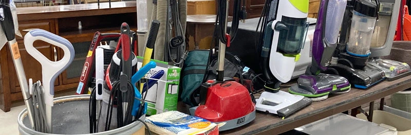 lineup of questionable vacuum cleaners from thrift store donation